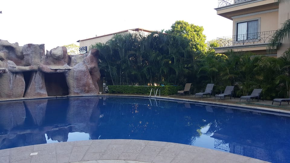 Pool has a waterfall and plenty of seating