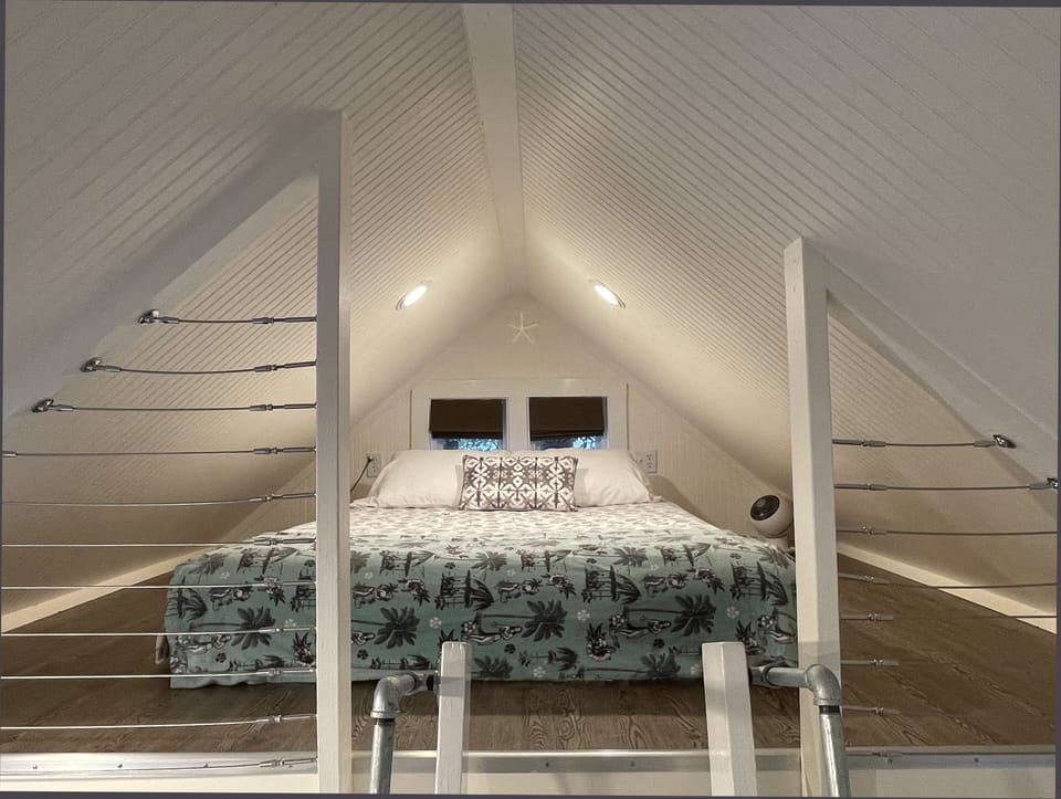 The sleeping loft with comfy queen bed – a serene place to hang out and chill.
