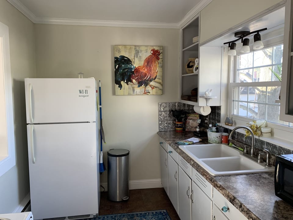 Kitchen has refrigerator, stove, microwave, Keurig & Mr. Coffee, & toaster.