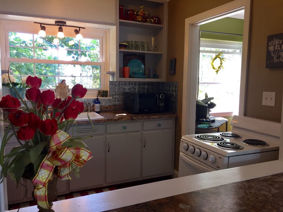 Our kitchen has pots, pans, plates, glasses, silverware, paper towels, dish soap