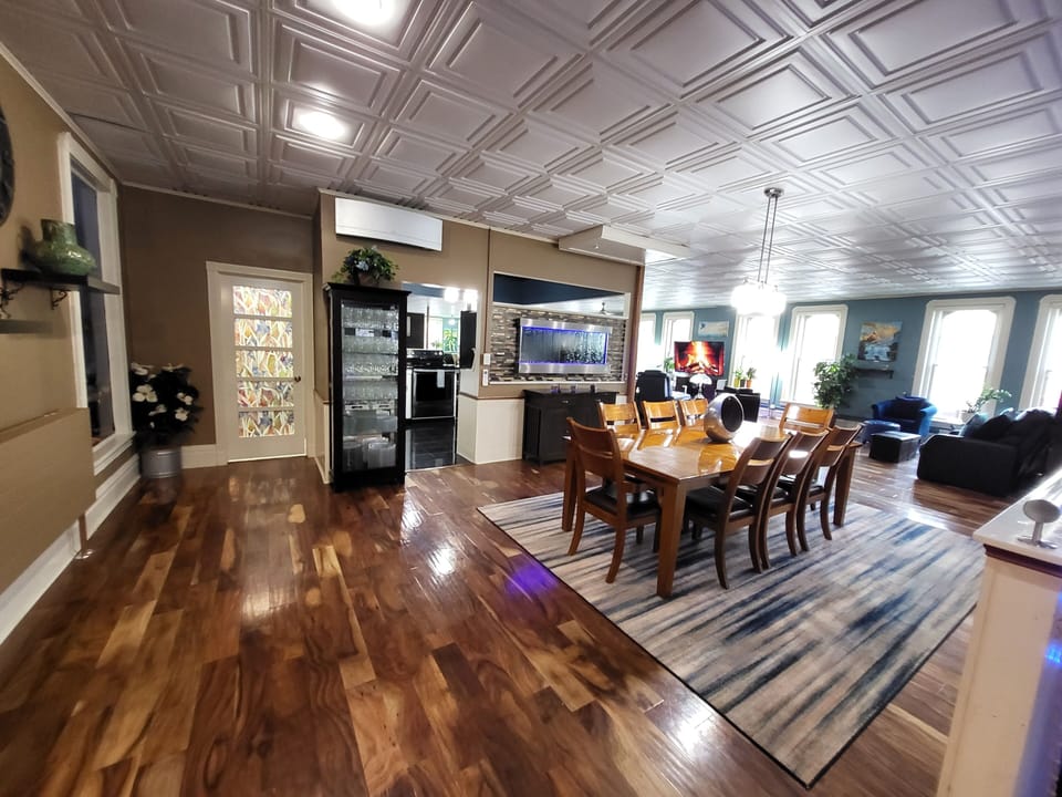 
8 padded leather chairs, dining table, kitchen & bathroom entrances