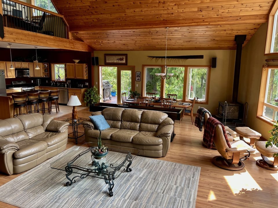 Great room features local art with lots of natural light through large windows