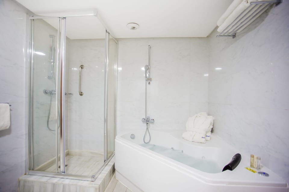 Prestige Suite | Bathroom | Designer toiletries, hair dryer, bathrobes, slippers