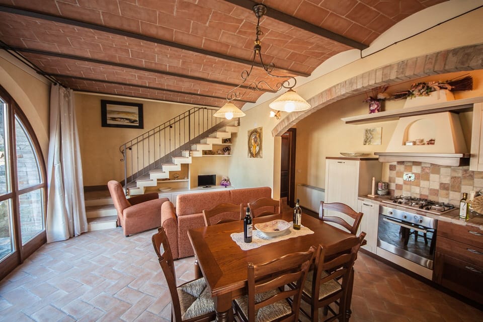 A typical Tuscan living room with a fully equipped kitchen