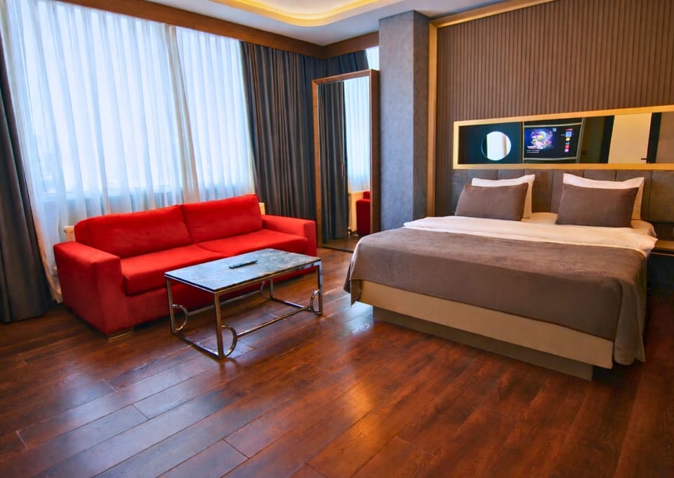 Deluxe Room, 1 Bedroom | Living area | 43-inch flat-screen TV with satellite channels, TV