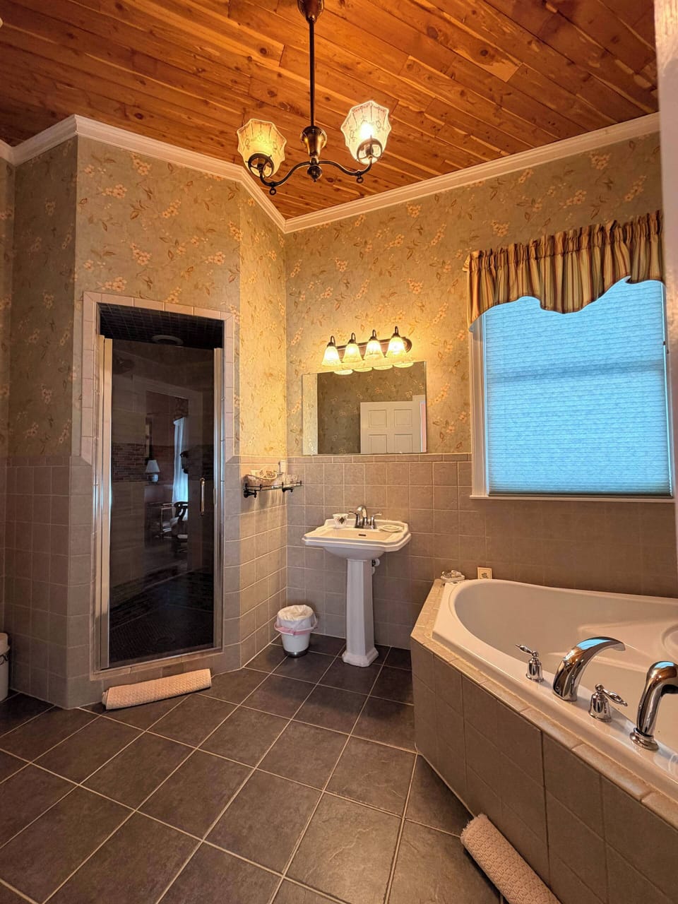 The Bates | Bathroom | Deep soaking tub, rainfall showerhead, designer toiletries, hair dryer