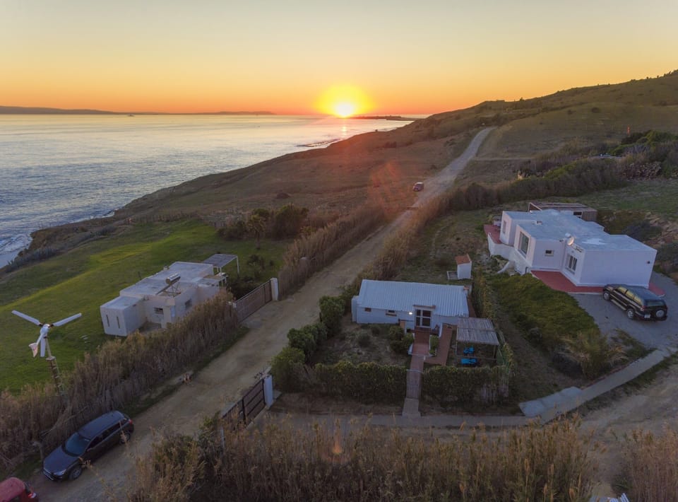 Aerial view of the 3 houses on the property at sunset in winter