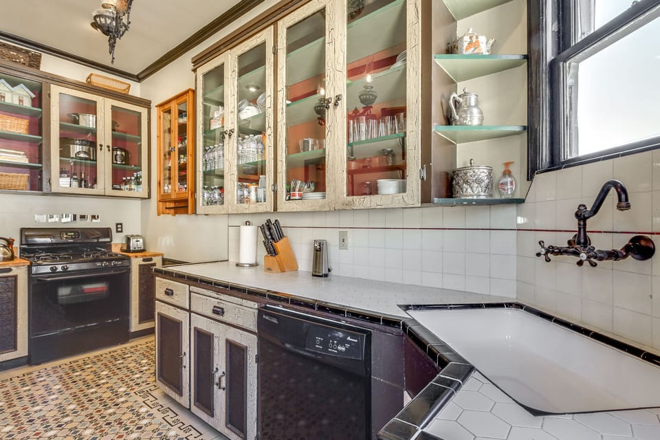 Original cabinets knife set, paper towels, toaster, gas oven & stove, dish was