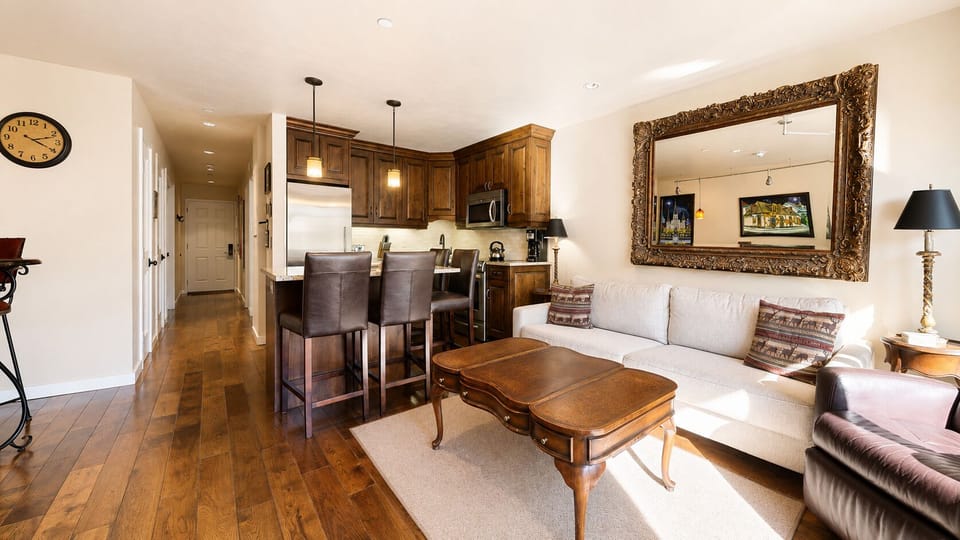 Unwind in your open-concept living space with warm wood accents, cozy seating, and a fully equipped kitchen inviting you to feel right at home.
