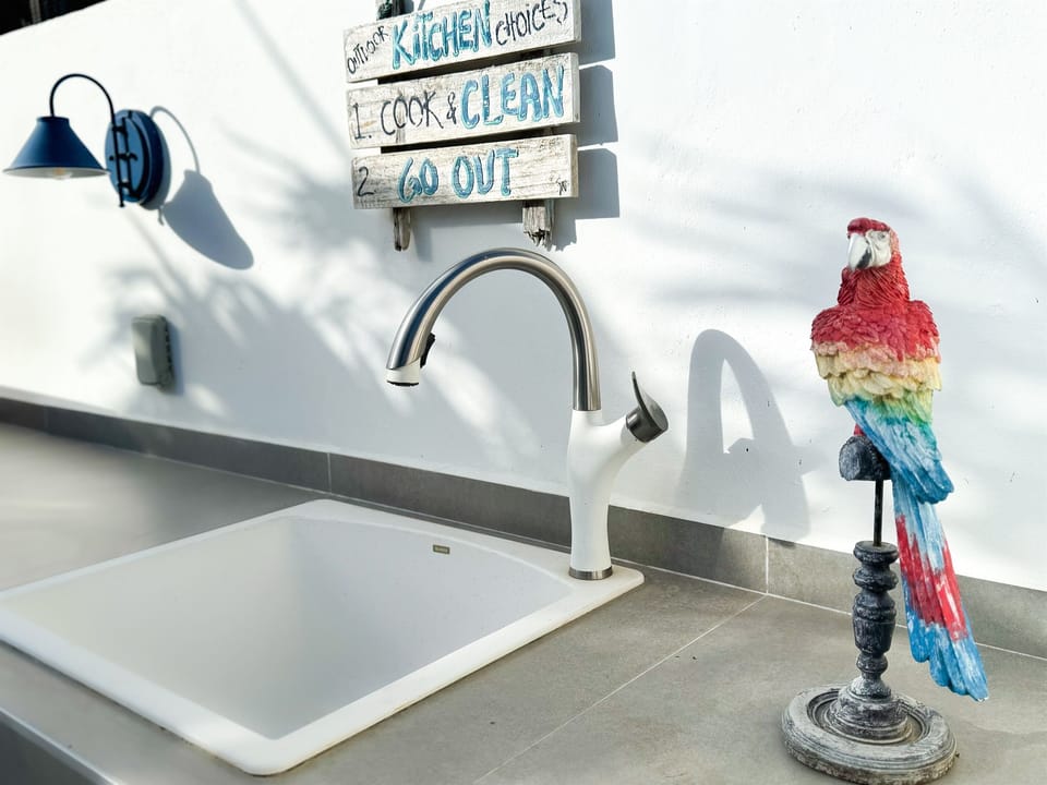Cook, grill, and gather in the shared outdoor kitchen after a day at the beach or on the reef.