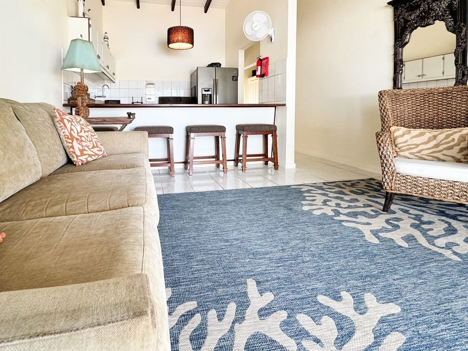A relaxed coastal vibe with comfortable seating that tropical accents.