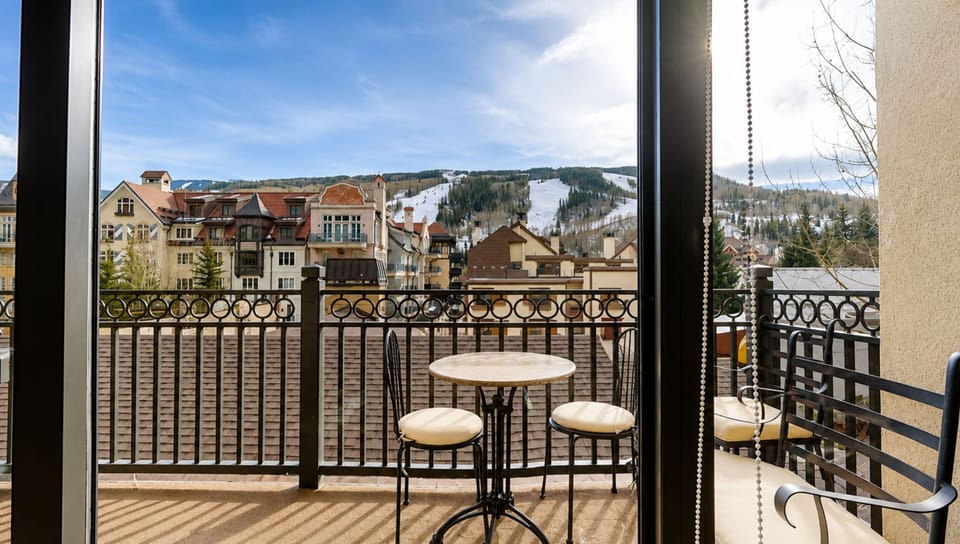 Your private balcony overlooks a charming alpine village and ski slopes, perfect for morning coffee or evening relaxation while taking in the mountain scenery.