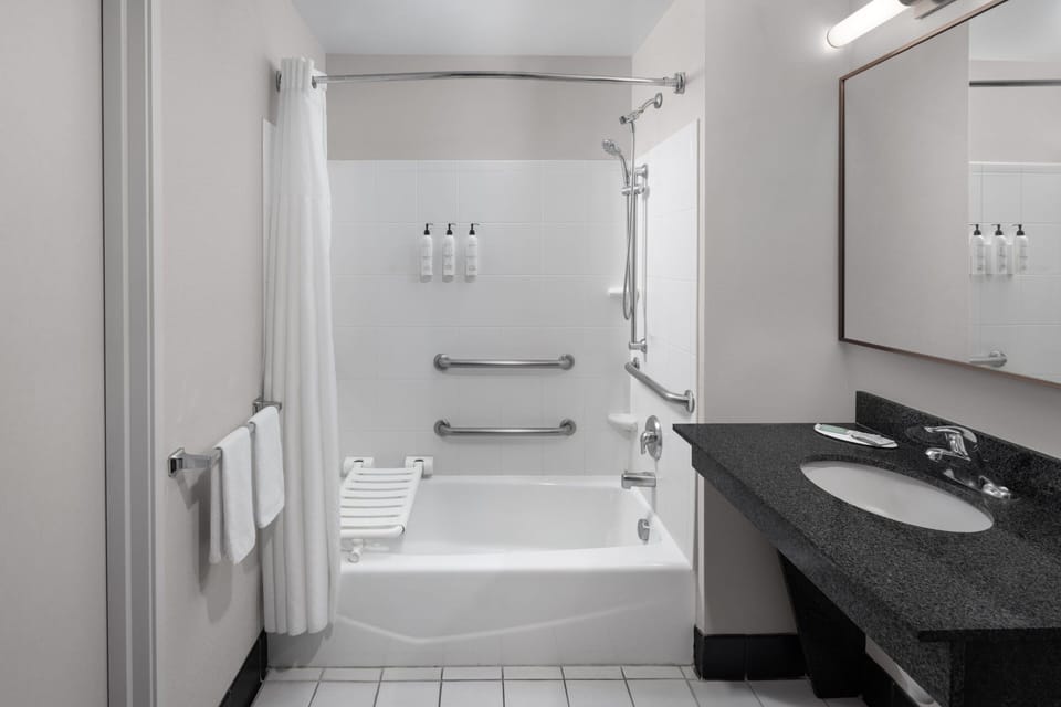 Standard Room, 1 King Bed (Mobility/Hearing Accessible, Tub) | Bathroom | Bathtub, hair dryer, towels