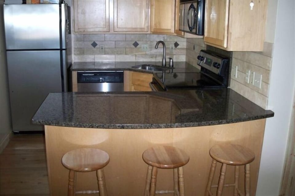 New, fully equipped kitchen, every amenity, bar seating & views.