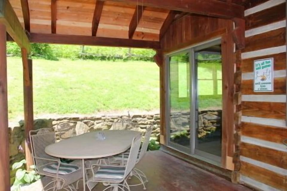 Outdoor covered patio has a table for 6.