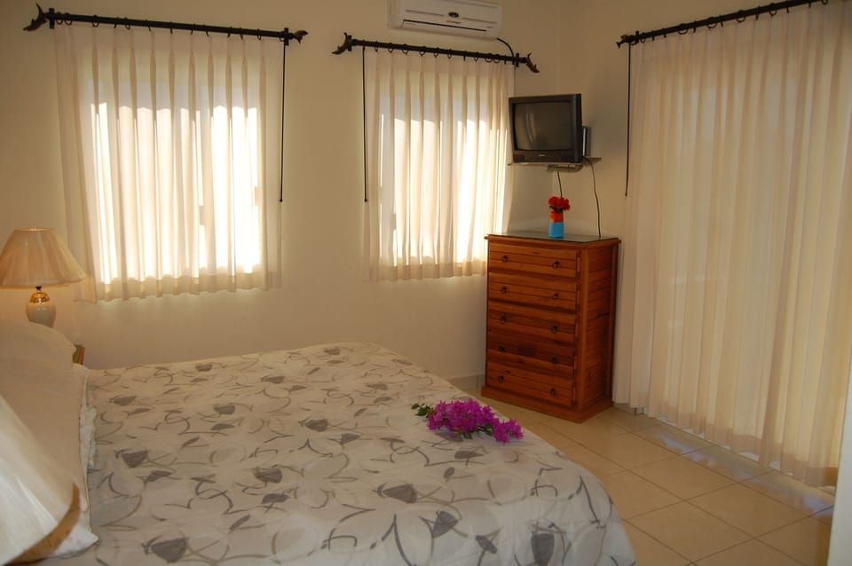 The master bedroom is large and spacious, with a king size bed.