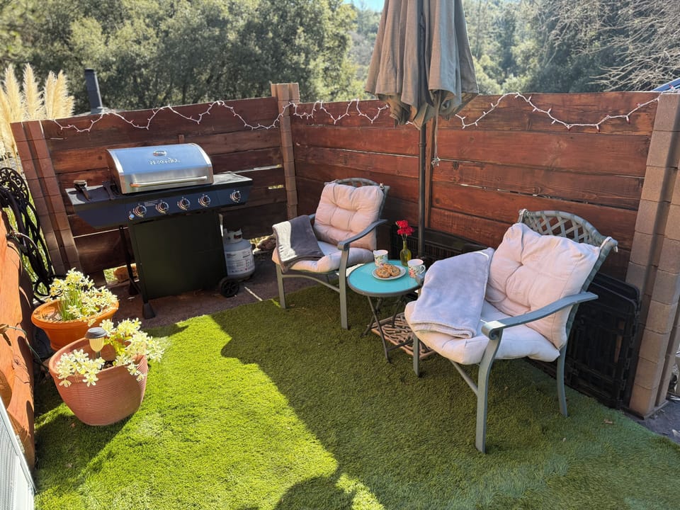 Private patio with bbq chairs and umbrella to enjoy your morning coffee