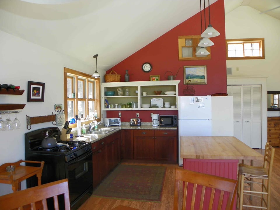 View of kitchen area and island taken from the dining table. 
