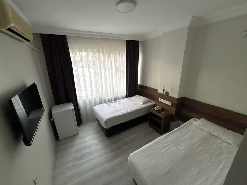 Twin Room | Minibar, desk, laptop workspace, free WiFi