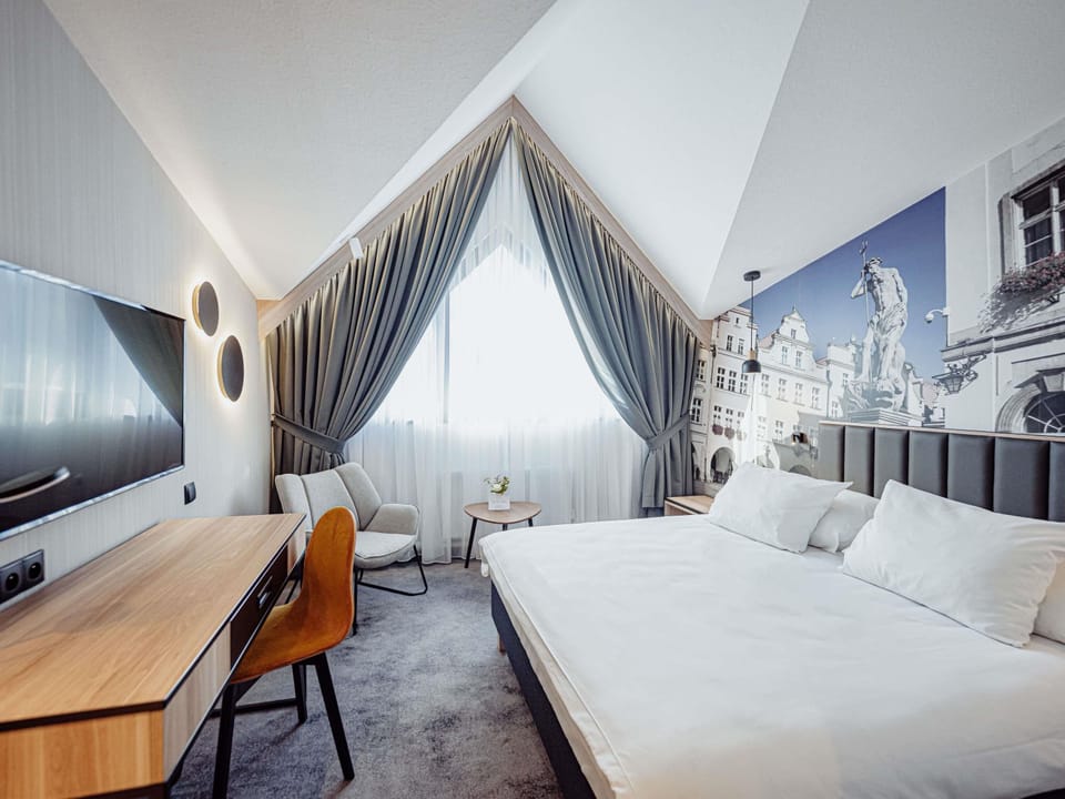 Hypo-allergenic bedding, desk, laptop workspace, blackout drapes