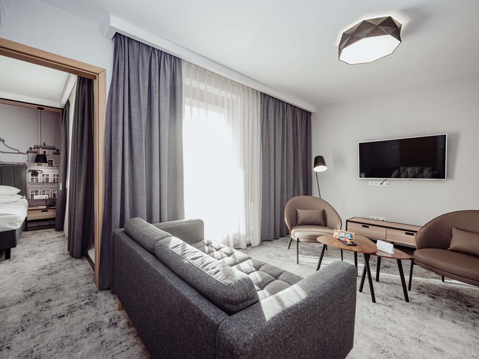 Hypo-allergenic bedding, desk, laptop workspace, blackout drapes
