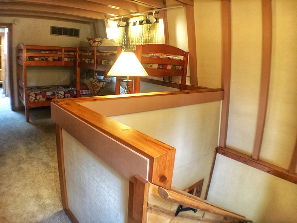 Upstairs loft with two sets of twin bunk beds.