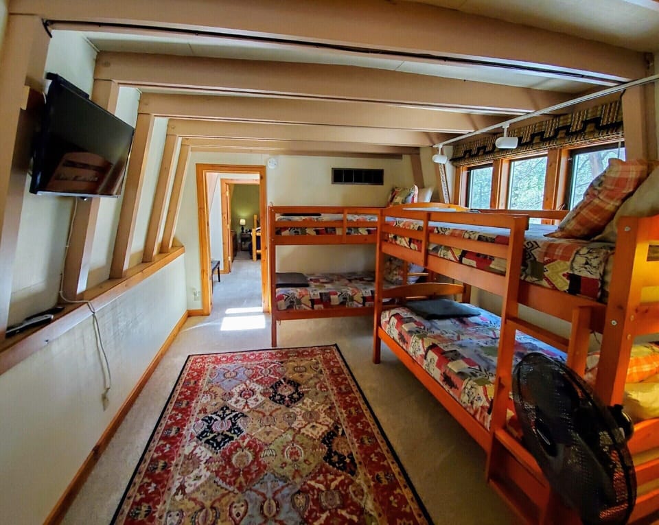 Upstairs loft with two sets of twin bunk beds.