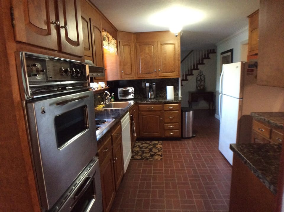 The kitchen is well stocked with dishes,  flatware, double oven.