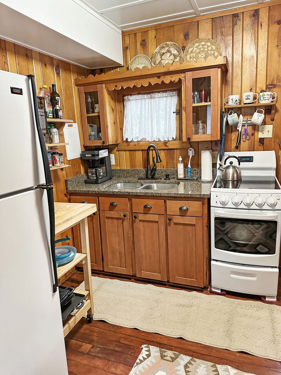 Kitchen with full fridge, small oven and coffee maker 