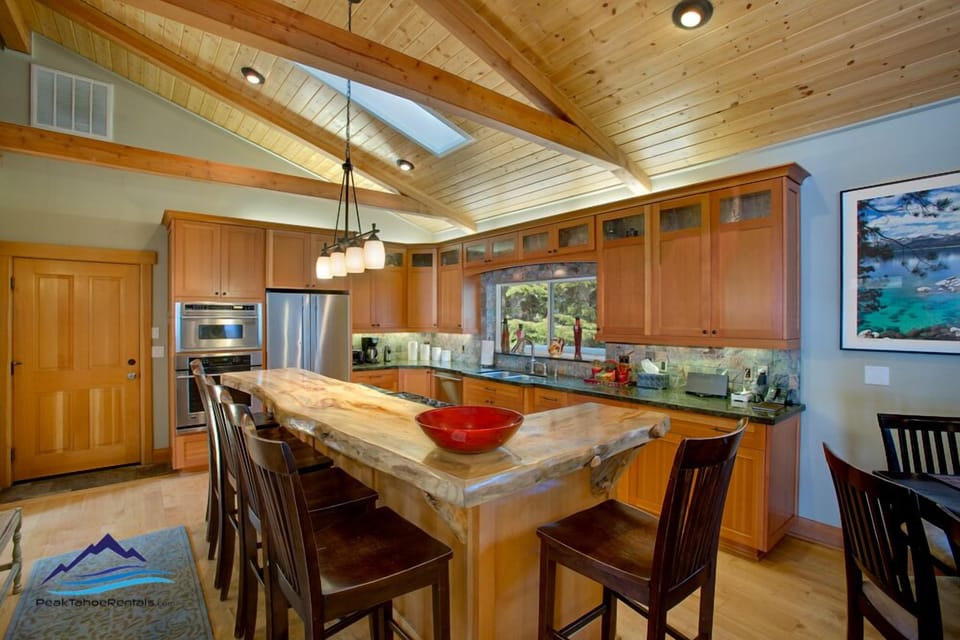 Chef`s kitchen fully equipped with GE Monogram appliances and vertical grain fir