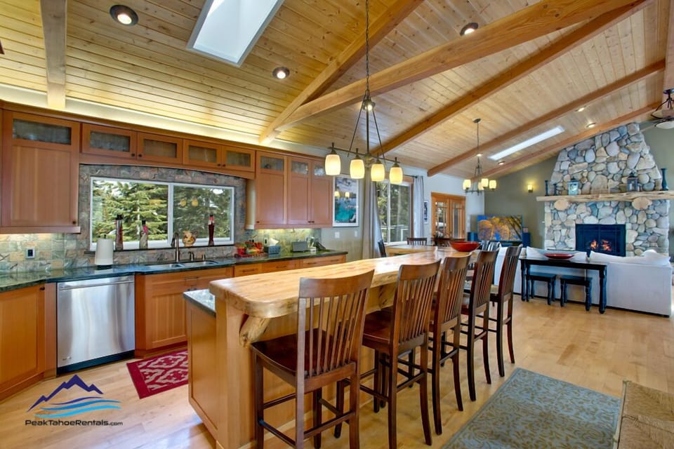 Bar Seating at kitchen with natural log slab bar top, vertical grain fir cabinet