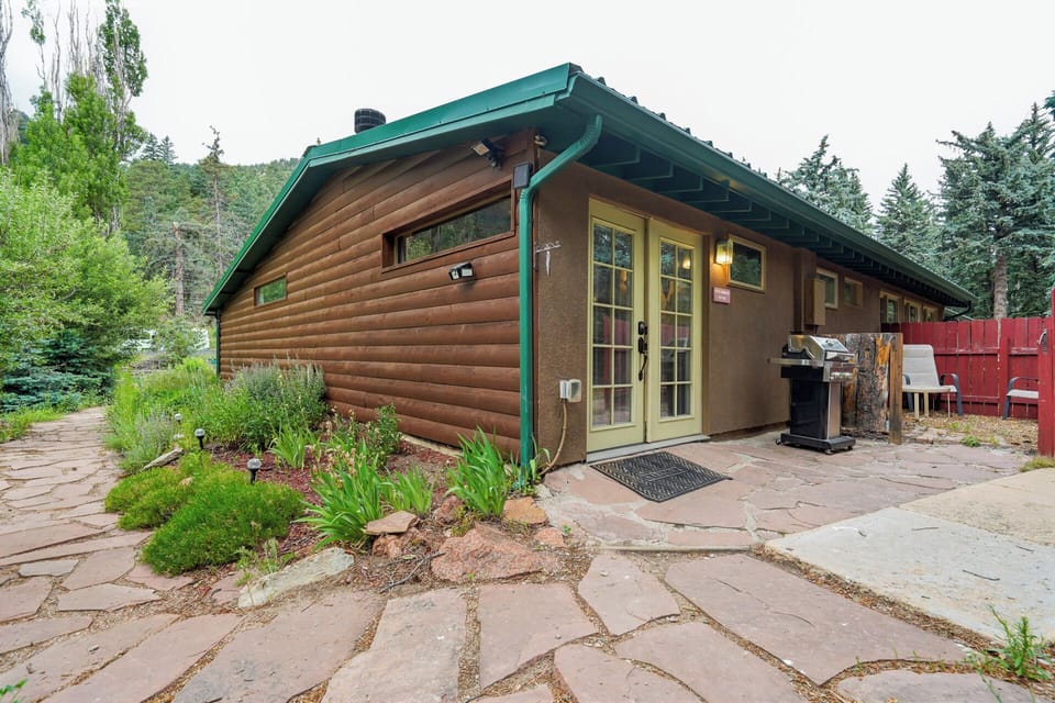 Path to private cottage entrance below towering trees and mountain views
