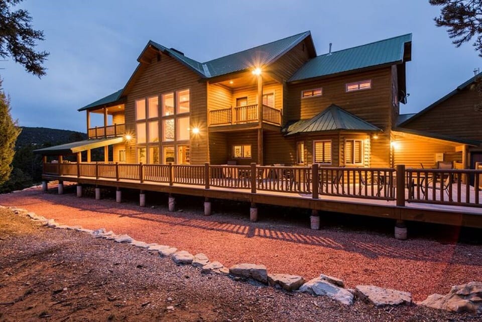 VIEW OF THE BACK OF THE HOUSE WITH THE MASSIVE WRAP AROUND DECK.