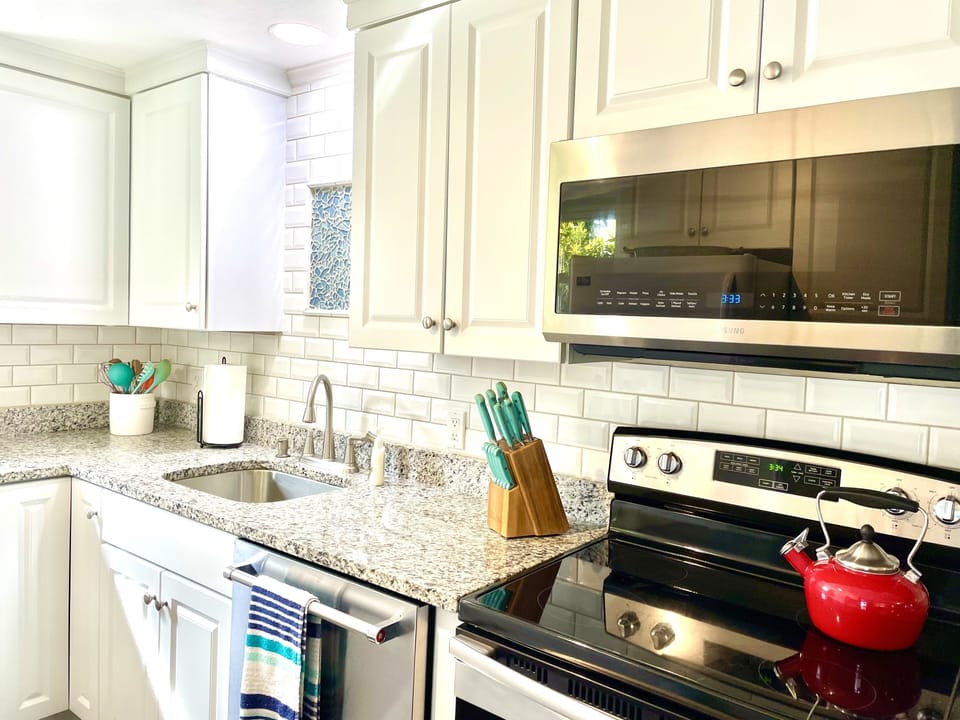 Newly renovated kitchen with granite counter tops and tiled backsplash.