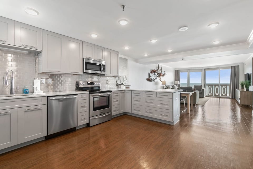 The kitchen is fully stocked with dishes, utensils, appliances, cooking supplies