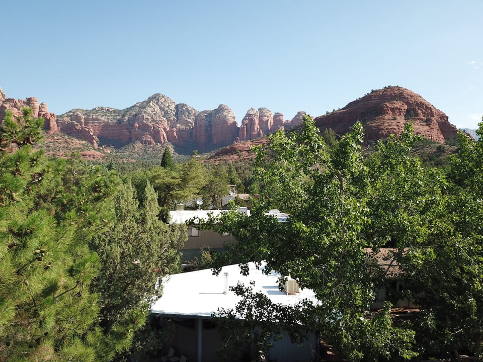 House (white roof) in foreground. Sugarloaf Mtn. and trailhead up the block.