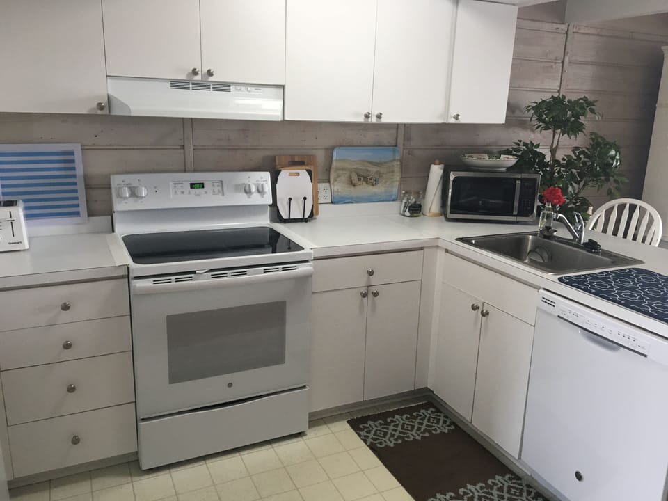 Fully-appointed kitchen with new dishwasher and stove to prep meals and snacks. 