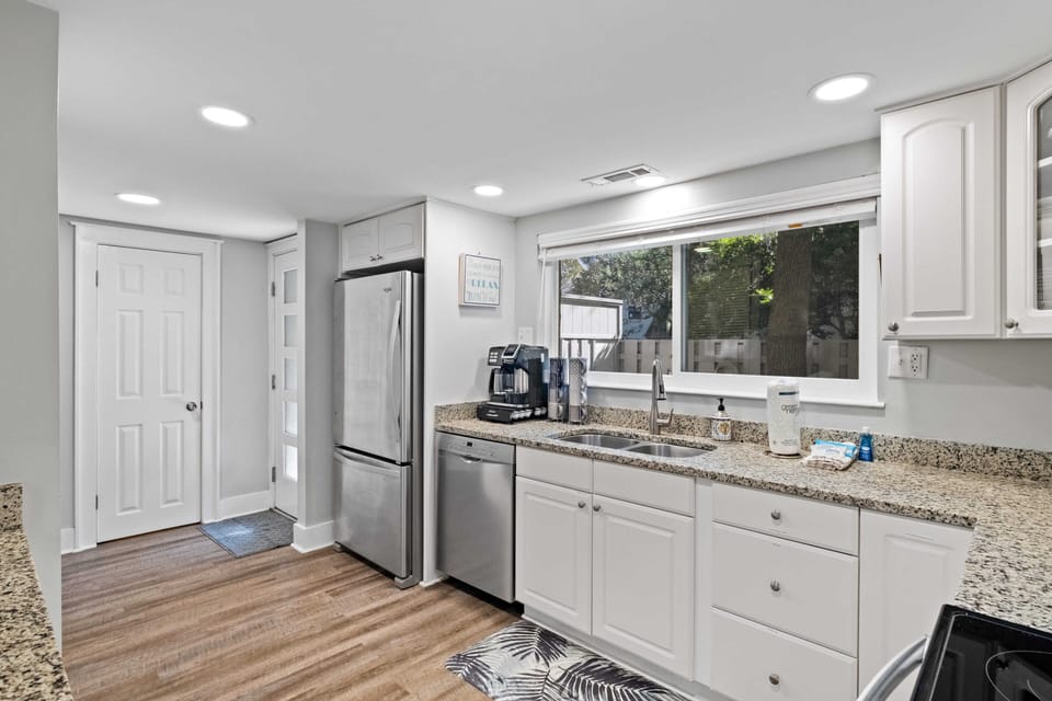 Open roomy kitchen looks out to front patio