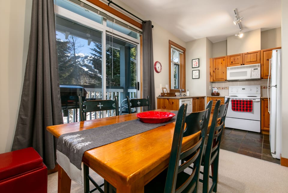 Dining area next to walk out patio/BBQ and well appointed kitchen