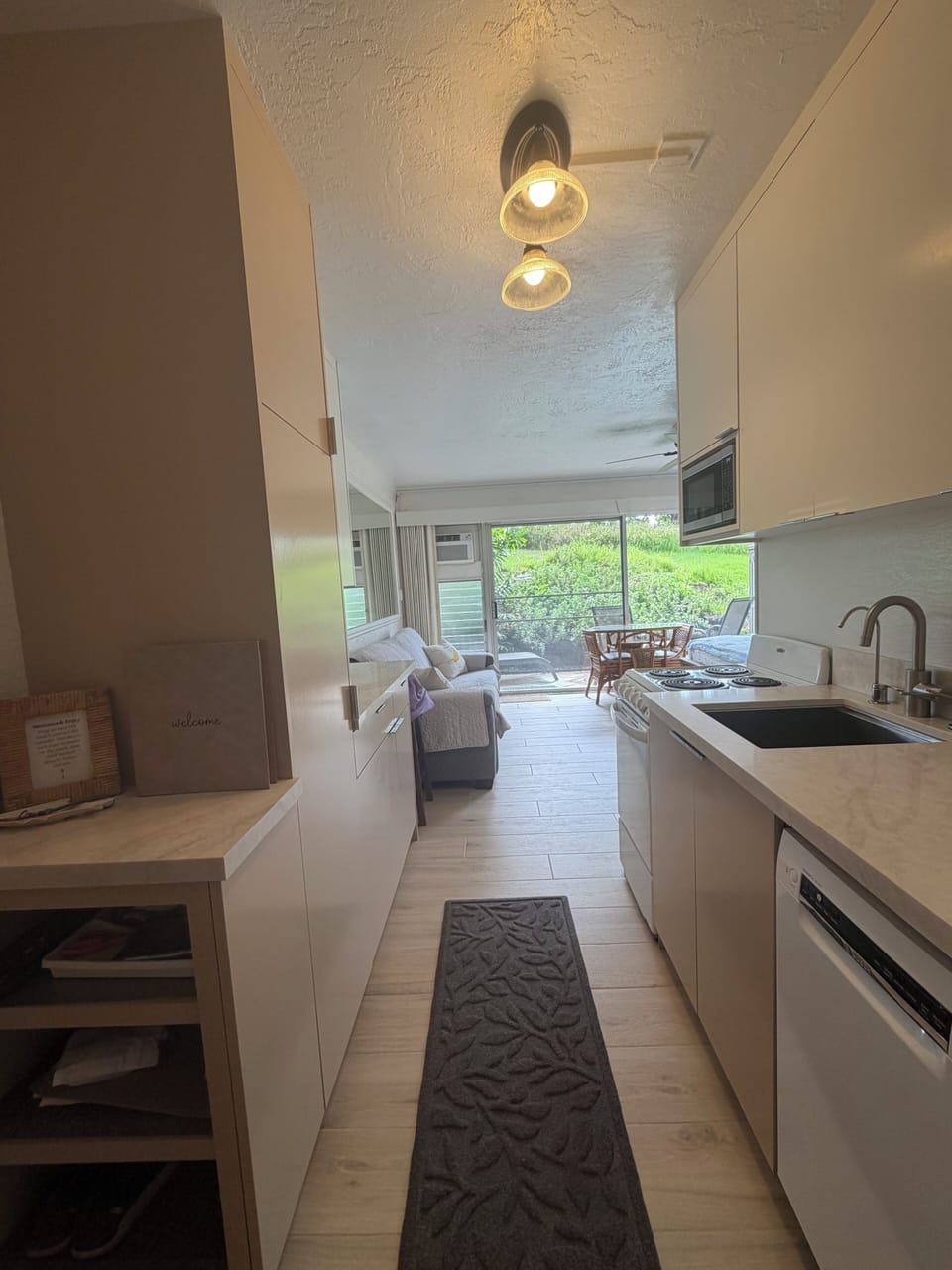 Kitchen area with fridge dishwasher, filtered water, and stove 
