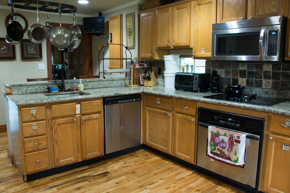 Cottage kitchen with new appliances and dishwasher. 