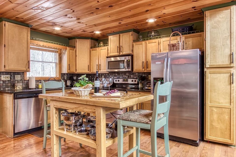 Open concept fully stocked kitchen with granite and stainless appliances