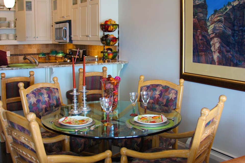 Dining room table set with candles, wine with dinner