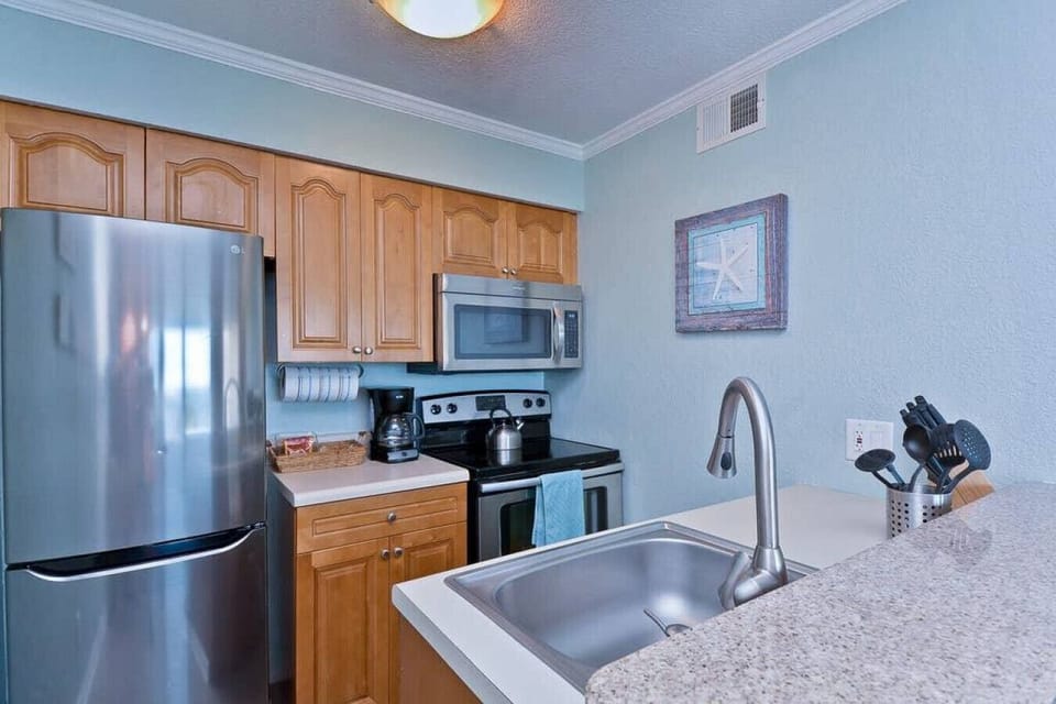 KITCHEN: Modern appliances and coastal decor create a perfect space for culinary adventures!