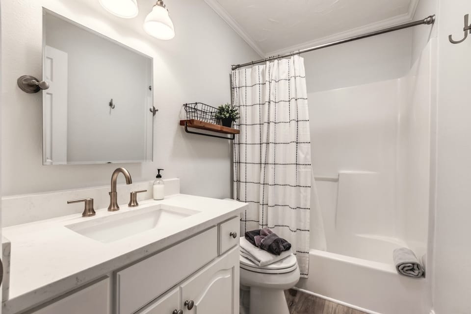 Master bedroom private bathroom with shower/tub combo. 