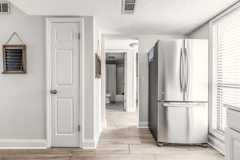 The kitchen is just off the main entrance and across from the hall bathroom. 
