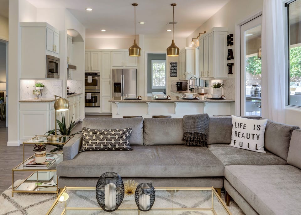 Newly remodeled living room with stacked stone media wall, modern furnishings and fireplace and open concept floor plan