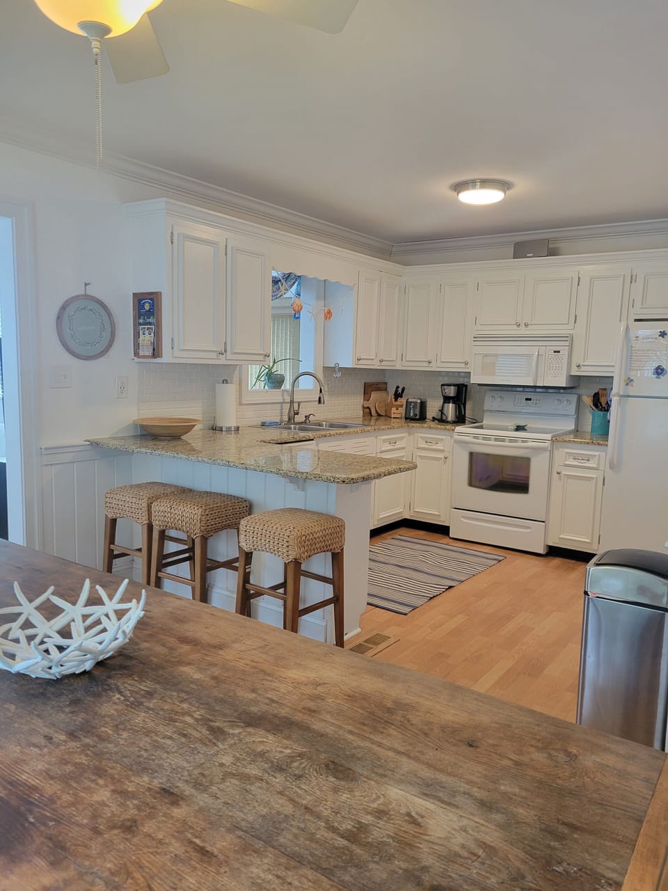 Eat-in kitchen with rustic dining table and breakfast bar.  