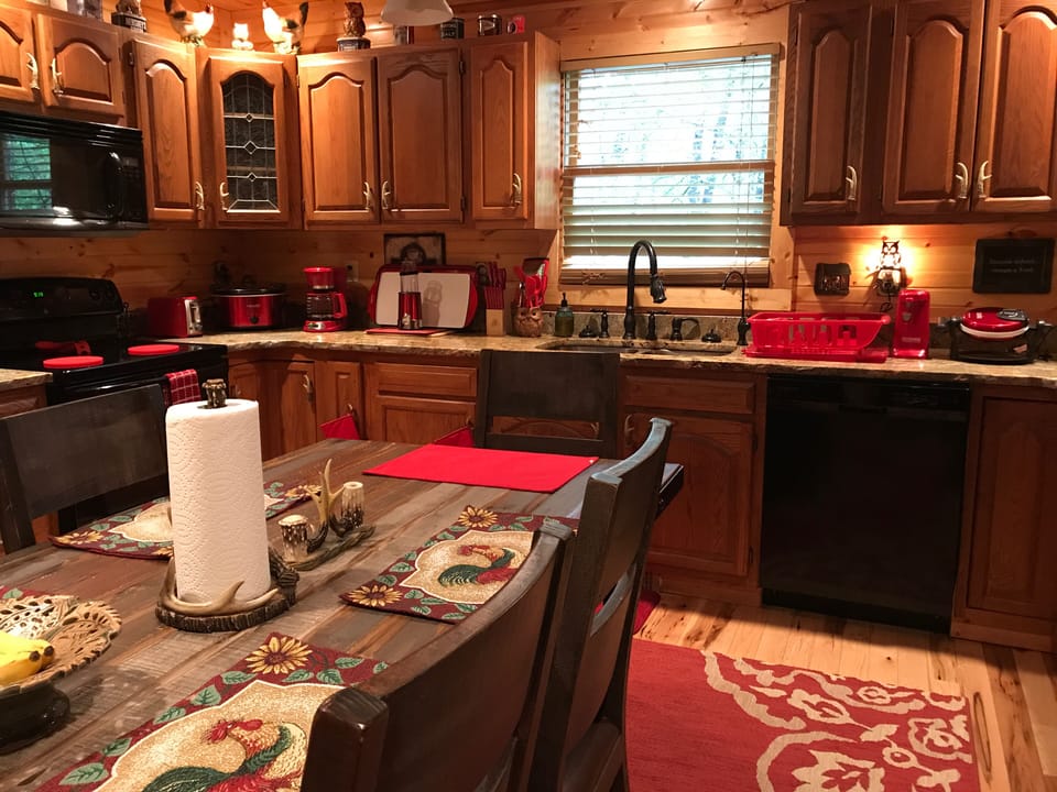 Kitchen has variety of appliances,utensils,everything needed to cook with.