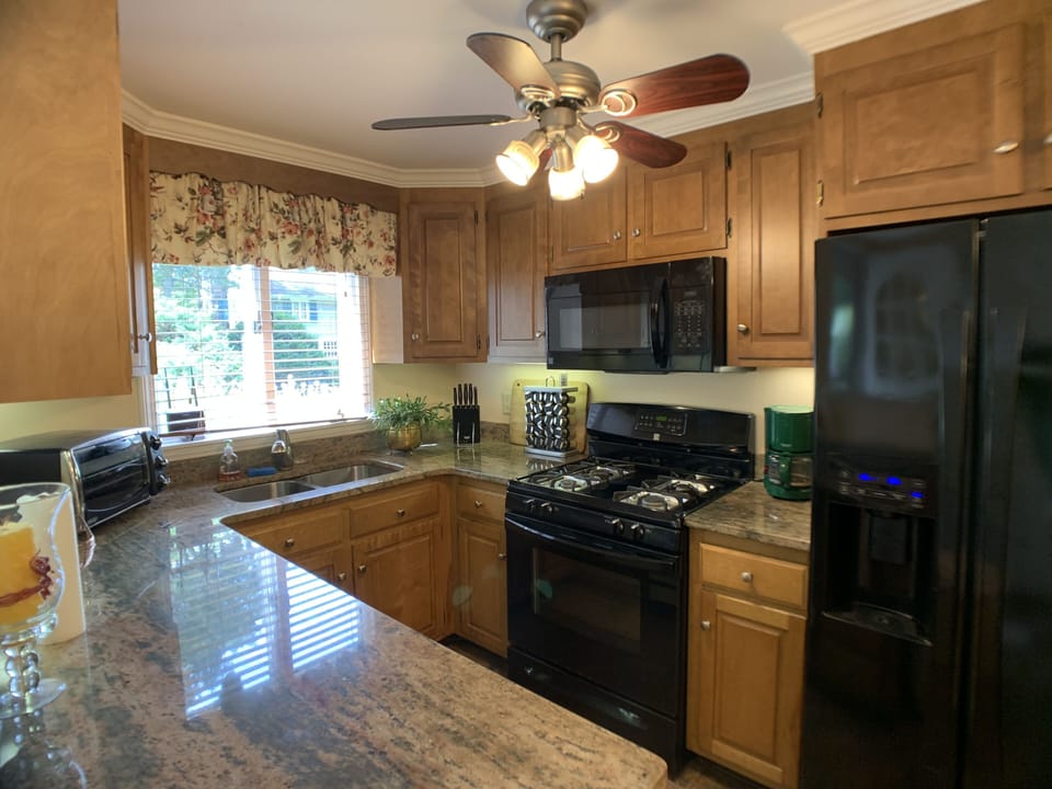 The gas stove has a microwave with a fan for the stove...